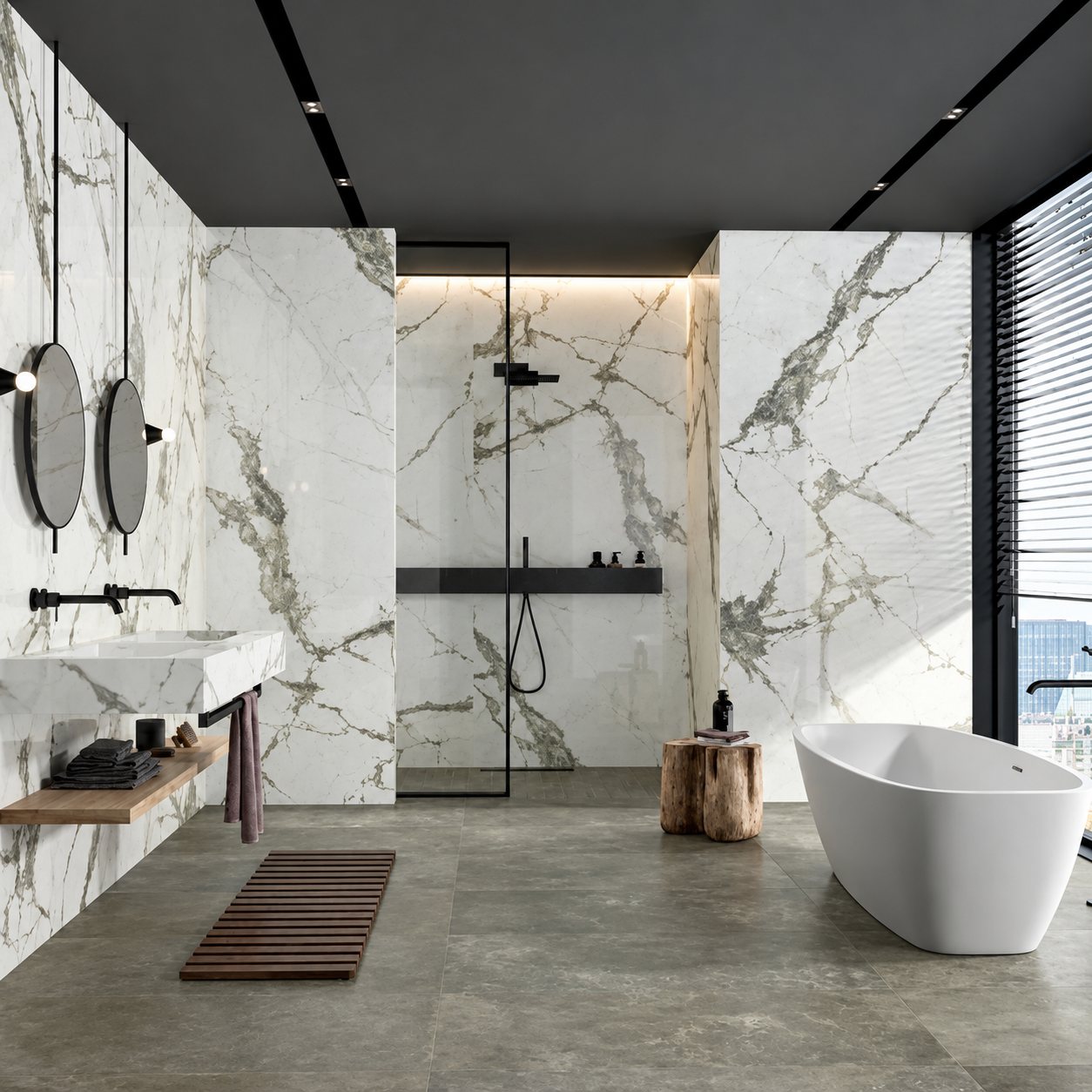 Une salle de bain contemporaine aux murs en marbre blanc veiné, avec douche vitrée, double miroir rond, vasque suspendue et baignoire ovale blanche sur un sol gris.